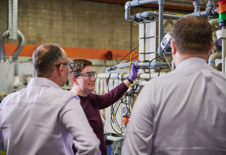 Group of people in the lab, around equipment